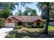 Charming single-story home surrounded by lush trees and green lawn at 1241 Leatherwood Dr, Altamonte Springs, FL 32714