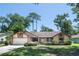 Charming single-story home with a well-manicured lawn and attached two-car garage at 1241 Leatherwood Dr, Altamonte Springs, FL 32714