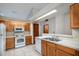 Kitchen area with tiled floor, bright lighting, and white appliances at 1241 Leatherwood Dr, Altamonte Springs, FL 32714