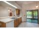 Kitchen area with tile flooring, dishwasher, and sliding glass doors to the porch at 1241 Leatherwood Dr, Altamonte Springs, FL 32714