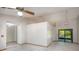 Open-concept living area featuring neutral walls, tiled flooring, and sliding glass doors at 1241 Leatherwood Dr, Altamonte Springs, FL 32714
