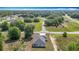 Scenic aerial view of home near intersecting road with mature trees surrounding at 12885 Sw 43, Ocala, FL 34473