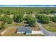 Beautiful aerial view of the home's roof, long driveway and landscaping with mature trees at 12885 Sw 43, Ocala, FL 34473