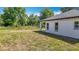 Exterior of home features a well maintained lawn with natural Florida landscaping at 12885 Sw 43, Ocala, FL 34473