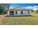 Exterior of home features a well maintained lawn with natural Florida landscaping at 12885 Sw 43, Ocala, FL 34473