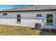 Exterior of home features a well maintained lawn and home air conditioning unit at 12885 Sw 43, Ocala, FL 34473