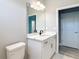 Bathroom with tile flooring, neutral walls, vanity with modern fixtures, a mirror, and a toilet at 12885 Sw 43, Ocala, FL 34473