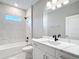Elegant bathroom with white marble tile, a soaking tub with shower, and a vanity with modern fixtures at 12885 Sw 43, Ocala, FL 34473