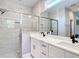 Modern bathroom features double vanity sinks, white marble tiling, glass shower, and black fixtures at 12885 Sw 43, Ocala, FL 34473