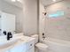 Bright bathroom features modern white tiling, black fixtures, and a tub and shower combo at 12885 Sw 43, Ocala, FL 34473