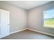 Comfortable bedroom showcasing neutral walls, new carpet, and a bright window with natural light at 12885 Sw 43, Ocala, FL 34473