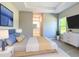 Well-furnished main bedroom offers a glimpse into the attached bathroom suite at 12885 Sw 43, Ocala, FL 34473