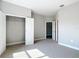 Bright bedroom featuring plush carpeting, neutral walls, an open closet, and access to another room at 12885 Sw 43, Ocala, FL 34473