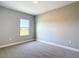 A bright bedroom features neutral walls, plush carpeting, and a sunlit window offering serene outside views at 12885 Sw 43, Ocala, FL 34473
