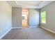 Carpeted main bedroom offers a view into the attached bathroom suite at 12885 Sw 43, Ocala, FL 34473
