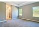 Spacious bedroom offers a view into the attached bathroom suite, and windows offer natural light at 12885 Sw 43, Ocala, FL 34473