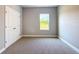 Bright bedroom featuring plush carpeting, neutral walls, window with outside views, and a double door closet at 12885 Sw 43, Ocala, FL 34473