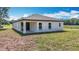 Charming, single-story home showcasing a neutral-tone exterior and well-maintained yard on a sunny day at 12885 Sw 43, Ocala, FL 34473