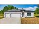 Charming single-story home with a three-car garage, neutral paint, and well-manicured lawn at 12885 Sw 43, Ocala, FL 34473
