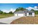 Charming single-story home with a three-car garage, neutral paint, and well-manicured lawn at 12885 Sw 43, Ocala, FL 34473