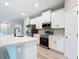 Modern kitchen with stainless steel appliances, quartz countertops, island with breakfast bar, and stylish finishes at 12885 Sw 43, Ocala, FL 34473