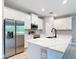 Modern kitchen with stainless steel appliances, quartz countertops, island with breakfast bar, and stylish finishes at 12885 Sw 43, Ocala, FL 34473