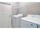 Well-organized laundry room with modern appliances, overhead shelving, and easy access to the rest of the home at 12885 Sw 43, Ocala, FL 34473