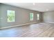 Spacious living room filled with natural light, complemented by stylish wood-look flooring at 12885 Sw 43, Ocala, FL 34473