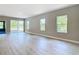 Bright and airy living room with wood-look floors and lots of natural light from sliding door and windows at 12885 Sw 43, Ocala, FL 34473