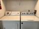 Bright laundry room features a side-by-side washer and dryer set for convenient chore completion at 14001 Fairway Island Dr # 525, Orlando, FL 32837