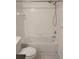Clean bathroom showcasing a shower-tub combo with white tiled walls, handheld shower and toilet at 14001 Fairway Island Dr # 525, Orlando, FL 32837