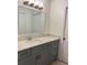 Modern bathroom vanity featuring gray cabinetry, white countertops, and contemporary lighting at 14001 Fairway Island Dr # 525, Orlando, FL 32837