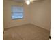 Bright bedroom with tiled floor, window, and ceiling fan, offering a clean and inviting space at 14001 Fairway Island Dr # 525, Orlando, FL 32837