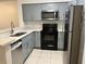 Charming kitchen showcasing gray cabinets, stainless appliances, and ample counter space at 14001 Fairway Island Dr # 525, Orlando, FL 32837