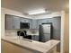 Well-lit kitchen featuring modern gray cabinets, new appliances, and white countertops at 14001 Fairway Island Dr # 525, Orlando, FL 32837