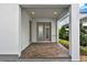 This backyard patio features brick flooring, an entry door, and a covered porch at 14826 Deaton Aly, Orlando, FL 32827
