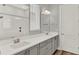 Neutral painted bathroom with double vanity, modern hardware, and decorative mirrors at 14826 Deaton Aly, Orlando, FL 32827