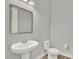Pedestal sink in a powder room with modern fixtures, toilet, and wood-look flooring at 14826 Deaton Aly, Orlando, FL 32827