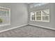 Bedroom featuring carpeted floor, neutral paint, trim, and multiple windows at 14826 Deaton Aly, Orlando, FL 32827