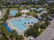 Aerial view of a resort-style pool area with lounge chairs and palm trees in a community setting at 14826 Deaton Aly, Orlando, FL 32827