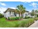 Side view of a modern home exterior showcasing manicured landscaping and a mature palm tree at 14826 Deaton Aly, Orlando, FL 32827