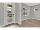 Entry way featuring a stylish front door with glass panels and wood-look floors at 14826 Deaton Aly, Orlando, FL 32827