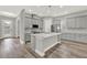 Well-equipped kitchen features a large island, stainless steel appliances, and gray cabinetry at 14826 Deaton Aly, Orlando, FL 32827