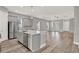 Open-concept kitchen featuring a central island, stainless steel appliances, and wood-look floors at 14826 Deaton Aly, Orlando, FL 32827