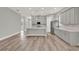 Spacious open layout featuring a modern kitchen with a large island, stainless steel appliances, and wood floors at 14826 Deaton Aly, Orlando, FL 32827
