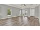 Bright living room with wood-look floors, neutral paint, and natural light from french doors at 14826 Deaton Aly, Orlando, FL 32827