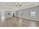 Open living space featuring wood-look floors, recessed lighting, and a direct view into the well-equipped kitchen at 14826 Deaton Aly, Orlando, FL 32827
