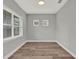 Neutral room features new wood floors, modern baseboards and multiple bright, light-filled windows at 14826 Deaton Aly, Orlando, FL 32827