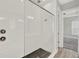 Glass enclosed shower with black hexagon floor tiles and herringbone shower surround at 14826 Deaton Aly, Orlando, FL 32827