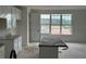 Bright kitchen featuring granite countertops, white cabinets and an island with natural light from large windows at 15089 Grove Lake Dr, Winter Garden, FL 34787
